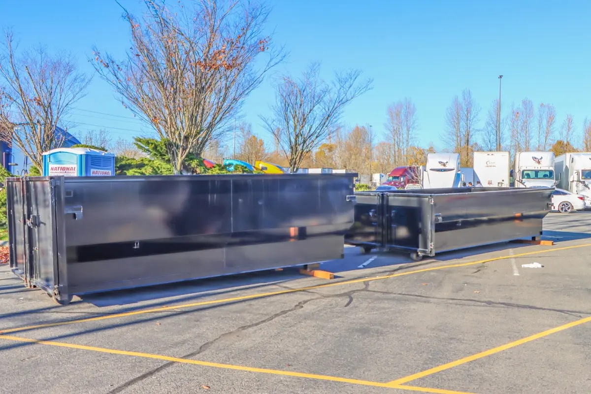 Professional dumpster rental service with roll-off container on residential driveway in Redlands